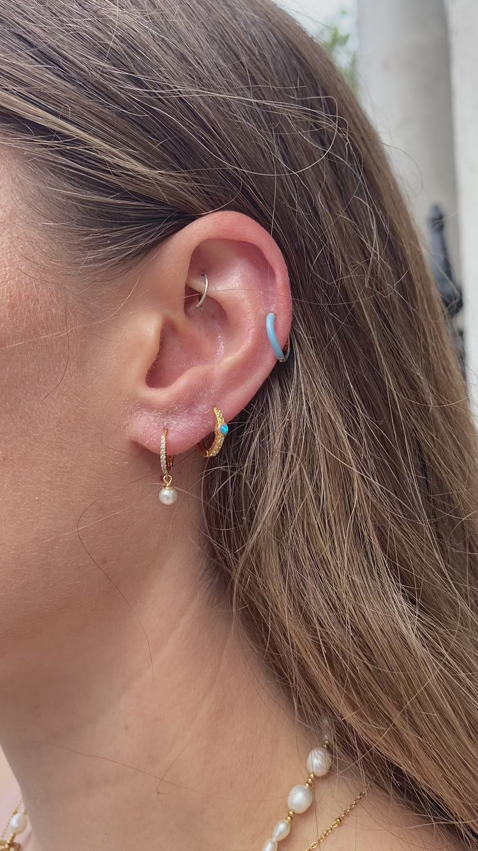 Blue Enamel Huggie Hoops, Reversible Earrings, Enamel-Coated Jewelry, Versatile Accessories, Blue Huggie Hoops, Wave-Shaped Silhouette, Dual-Sided Earrings, Dazzling Crystal Embellishments, Understated Elegance, Fashionable Reversibility
